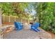 Cozy fire pit area with Adirondack chairs surrounded by trees and a privacy fence, ideal for gatherings at 3925 Sheldon Ne Dr, Atlanta, GA 30342