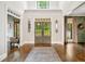 Grand foyer with a soaring ceiling, hardwood floors, and statement doors that lead to verdant outdoors at 3925 Sheldon Ne Dr, Atlanta, GA 30342