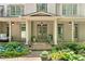 Elegant front porch with stone steps, columns, and tasteful landscaping, creating a welcoming entrance at 3925 Sheldon Ne Dr, Atlanta, GA 30342