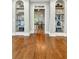 Elegant hallway featuring hardwood floors and built-in bookshelves for displaying decor and books at 3925 Sheldon Ne Dr, Atlanta, GA 30342