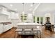 Gourmet kitchen with white cabinets, a large island, stainless steel appliances and a cozy breakfast nook at 3925 Sheldon Ne Dr, Atlanta, GA 30342