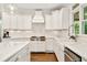Bright kitchen featuring white cabinets, stainless steel appliances, and subway tile backsplash at 3925 Sheldon Ne Dr, Atlanta, GA 30342