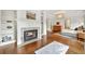 Main bedroom featuring a fireplace, hardwood floors, tray ceiling, and adjacent sitting room at 3925 Sheldon Ne Dr, Atlanta, GA 30342