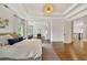 Spacious main bedroom featuring hardwood floors, tray ceiling, adjacent sitting room, and lots of natural light at 3925 Sheldon Ne Dr, Atlanta, GA 30342