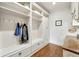 Mud room featuring custom cabinets, shelving, hanging hooks, and a built-in desk with natural wood finish at 3925 Sheldon Ne Dr, Atlanta, GA 30342