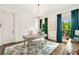 Bright office with hardwood floors, white walls, teal curtains, modern lighting, and a view to the backyard at 3925 Sheldon Ne Dr, Atlanta, GA 30342