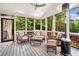 Cozy screened porch featuring comfortable seating and views of the beautiful backyard at 3925 Sheldon Ne Dr, Atlanta, GA 30342