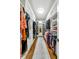 Spacious walk-in closet features custom shelving, a mirrored door, and a plush rug over hardwood floors at 3925 Sheldon Ne Dr, Atlanta, GA 30342