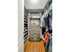 Custom walk-in closet with wooden floor, shelves, drawers, and hanging rods for clothes and accessories at 3925 Sheldon Ne Dr, Atlanta, GA 30342