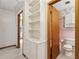 Hallway view of pink bathroom featuring a toilet and vanity with floral wallpaper at 509 Woodland Ln, Lawrenceville, GA 30043