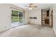 This bedroom has carpet, a ceiling fan, and sliding glass door to the backyard at 509 Woodland Ln, Lawrenceville, GA 30043