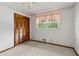 Bedroom with light carpet, ceiling fan, and a closet with trees outside at 509 Woodland Ln, Lawrenceville, GA 30043