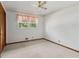 Bedroom with light carpet, ceiling fan, and a window with trees outside at 509 Woodland Ln, Lawrenceville, GA 30043