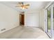 The bedroom has neutral carpet, a ceiling fan, closet, and sliding glass door to the backyard at 509 Woodland Ln, Lawrenceville, GA 30043