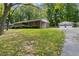 A brick home with a carport and a detached two-car garage, set in a lush green lawn at 509 Woodland Ln, Lawrenceville, GA 30043