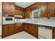 Charming kitchen boasts wood cabinets, white countertops, and standard appliances for meal preparation at 509 Woodland Ln, Lawrenceville, GA 30043