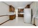 Traditional kitchen features ample wood cabinetry, and white appliances at 509 Woodland Ln, Lawrenceville, GA 30043