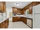 Kitchen featuring wood cabinets, white countertops, and classic appliances in a cozy space at 509 Woodland Ln, Lawrenceville, GA 30043