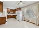 Traditional kitchen with wood cabinets, white appliances and a window at 509 Woodland Ln, Lawrenceville, GA 30043