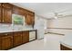 Traditional style kitchen with wood cabinets and white appliances, plus eat-in area at 509 Woodland Ln, Lawrenceville, GA 30043