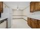 Kitchen features wood cabinets, white appliances, and vintage wallpaper plus eat in area at 509 Woodland Ln, Lawrenceville, GA 30043