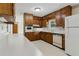 Kitchen has ample wood cabinets, white counter, and standard appliances, plus eat-in area at 509 Woodland Ln, Lawrenceville, GA 30043