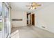 Living room with carpet and sliding glass door to backyard, plus view into kitchen at 509 Woodland Ln, Lawrenceville, GA 30043