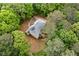 Aerial view of a cozy home nestled within lush, dense trees at 569 Hale Mountain Ct, Hiram, GA 30141