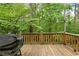Large, inviting back deck offers serene views of lush greenery at 569 Hale Mountain Ct, Hiram, GA 30141