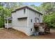 Back exterior view of the home with a deck overlooking the wooded backyard at 569 Hale Mountain Ct, Hiram, GA 30141