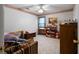 This bedroom has patterned wall trim, a ceiling fan, and a nice loveseat at 569 Hale Mountain Ct, Hiram, GA 30141