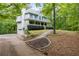 Side view of a two story home with a long driveway and lush surroundings at 569 Hale Mountain Ct, Hiram, GA 30141