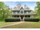 Charming two-story home with a welcoming front porch and lush landscaping at 569 Hale Mountain Ct, Hiram, GA 30141