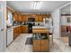Traditional kitchen featuring wood cabinets, black appliances, and a mobile island at 569 Hale Mountain Ct, Hiram, GA 30141