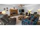 A well lit living room with stone fireplace and comfortable seating at 569 Hale Mountain Ct, Hiram, GA 30141