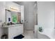 Well-lit bathroom showcasing a vanity, tub with tile surround, and separate shower at 569 Hale Mountain Ct, Hiram, GA 30141