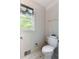 Quaint powder room featuring heart wallpaper, window, and toilet at 569 Hale Mountain Ct, Hiram, GA 30141