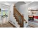 Hallway featuring a staircase to the upper level next to the front door and dining room at 569 Hale Mountain Ct, Hiram, GA 30141