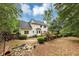 Backyard with a well-manicured lawn and lush landscaping at 115 Blue Ridge Trl, Powder Springs, GA 30127