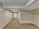 Unfinished basement area with neutral carpet, white walls, and access to a bathroom at 115 Blue Ridge Trl, Powder Springs, GA 30127