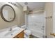 Cozy bathroom featuring wood vanity, an oval mirror, and a shower-tub combo at 115 Blue Ridge Trl, Powder Springs, GA 30127