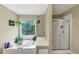 Serene bathroom boasting a soaking tub, glass-enclosed shower, and a nature view at 115 Blue Ridge Trl, Powder Springs, GA 30127