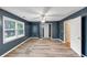 Bedroom with plank flooring, a ceiling fan, and windows that provide natural light at 115 Blue Ridge Trl, Powder Springs, GA 30127