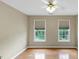Cozy bedroom with hardwood floors, ceiling fan, and two windows with natural light at 115 Blue Ridge Trl, Powder Springs, GA 30127