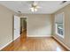 Bedroom with hardwood floors, a ceiling fan, and an open doorway at 115 Blue Ridge Trl, Powder Springs, GA 30127