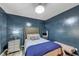Cozy bedroom with a tufted headboard bed, bedside table with a lamp, and a mirror at 115 Blue Ridge Trl, Powder Springs, GA 30127