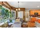 Eat-in kitchen features a black table, chandelier, and 