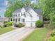 Charming two-story traditional home featuring a two-car garage, and a beautifully landscaped front yard at 115 Blue Ridge Trl, Powder Springs, GA 30127