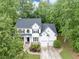 Beautifully landscaped two-story house with black shutters and two-car garage at 115 Blue Ridge Trl, Powder Springs, GA 30127