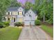 Charming two-story traditional home featuring a two-car garage, and a beautifully landscaped front yard at 115 Blue Ridge Trl, Powder Springs, GA 30127